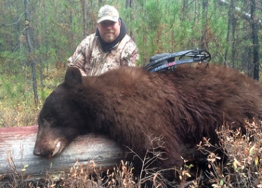 Jason Arnold with the black bear he took in Deschutes County.