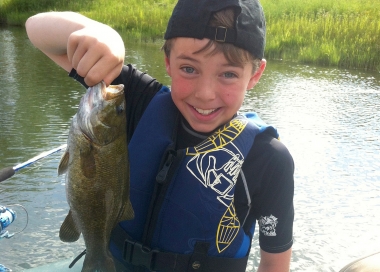 Young anglers shows off a nice smallmouth bass on the John Day River