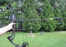 photo of a bow held at full draw with a draw lock